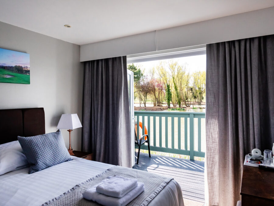 Interior of a terrace cabin at The Vale Country Club looking out over the balcony and lake